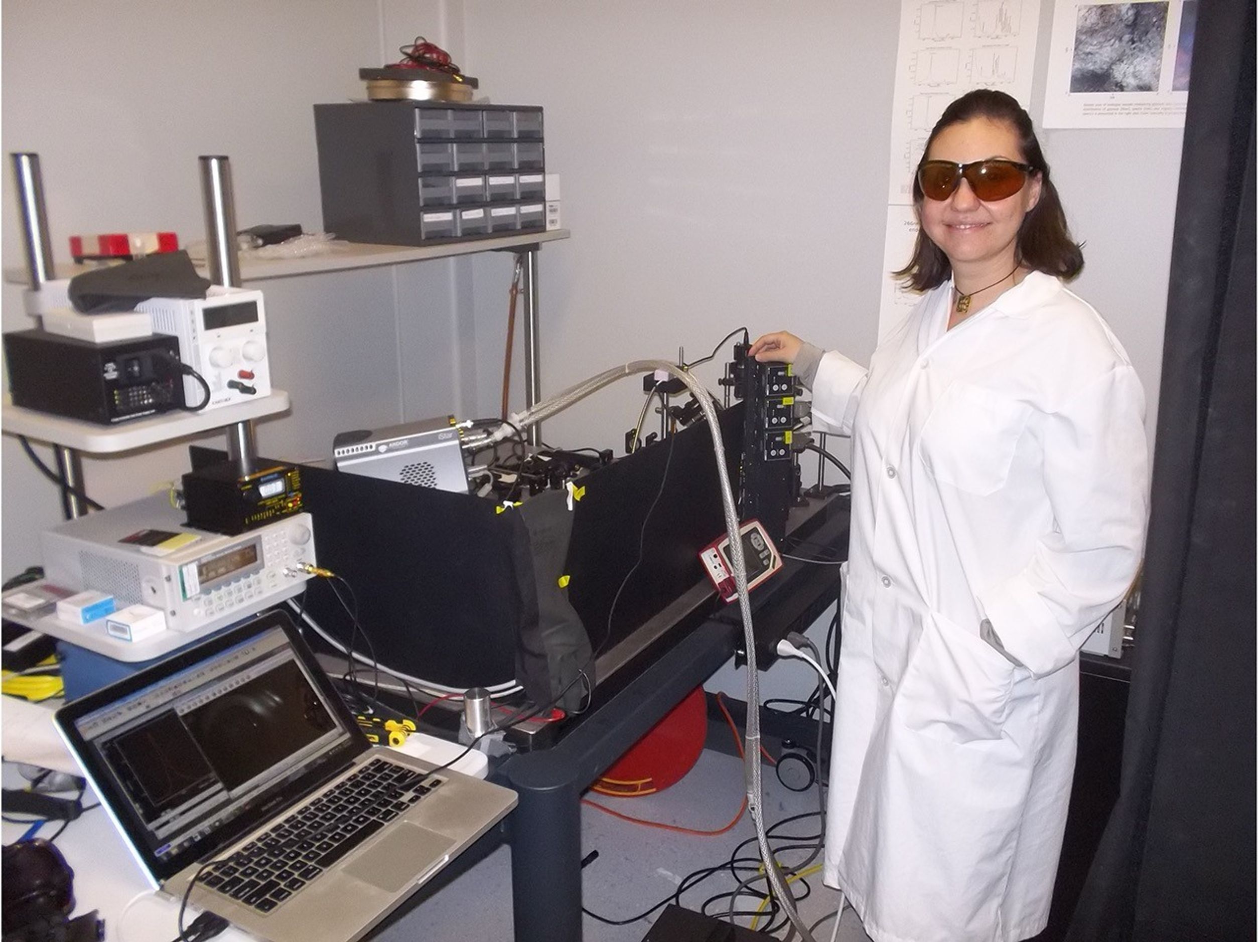 A person in a white lab coat in a science lab.